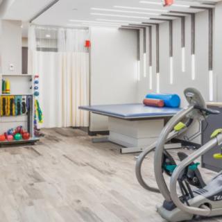A modern gym interior with exercise equipment and a workout station.