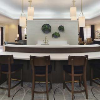 A modern bar area with stylish seating and elegant lighting fixtures.