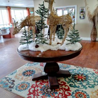 A beautifully decorated table featuring reindeer and trees, creating a festive atmosphere.