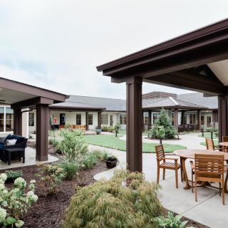 A well-maintained courtyard with outdoor seating and lush landscaping.
