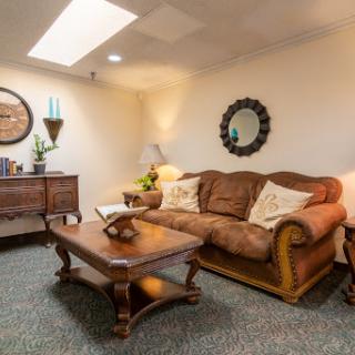 A cozy living room featuring a comfortable sofa and ornate coffee table.