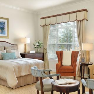 A beautifully designed bedroom featuring elegant furniture, soft lighting, and a welcoming ambiance.