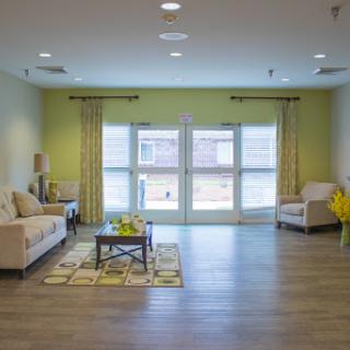 A spacious and modern living room with comfortable seating and ample natural light.