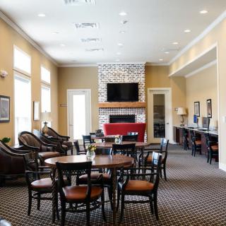 A spacious living room with modern furniture, a fireplace, and a television.