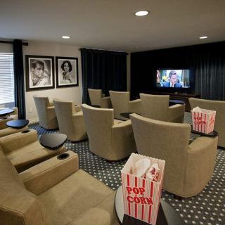 A cozy home theater setup with comfortable seating and popcorn ready for a movie night.