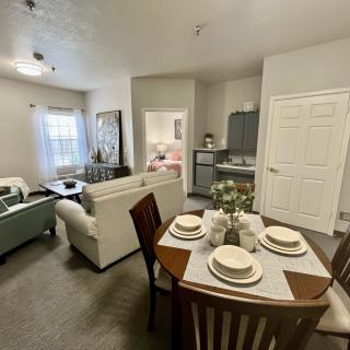 A modern apartment interior featuring an open living and dining area with stylish furniture.