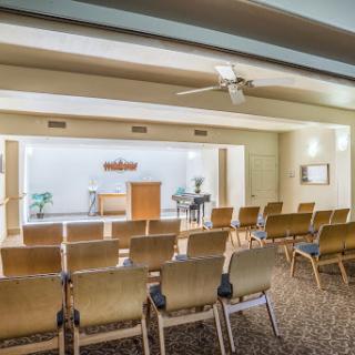 A serene chapel interior set up with seating for a gathering.