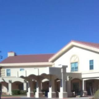 A residential building with arches under a clear blue sky.