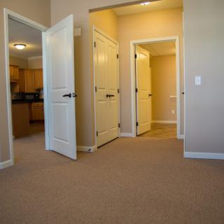 A view of a hallway with multiple doors leading to different rooms.