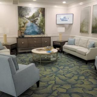 A modern living room with comfortable seating and decorative artwork.