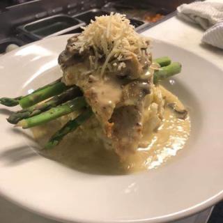 Gourmet dish with meat and asparagus in a creamy sauce.