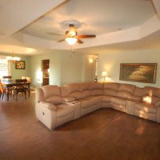 Spacious living room with a large sectional sofa and an adjoining dining area.