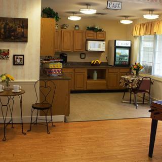A cozy kitchen and dining area with wooden cabinets and a small dining table, featuring homey decor.