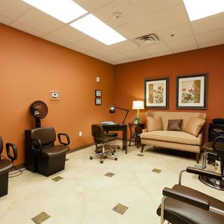 A cozy salon room with comfortable seating and modern decor.