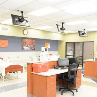 A modern hospital nurses' station with medical equipment and computers.