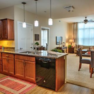 Modern open-concept kitchen with an island counter and adjacent dining area.