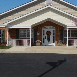 A quaint residential building with a welcoming entrance and a small porch.