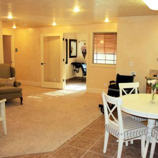 A cozy open living room and dining area with comfortable seating and warm lighting.