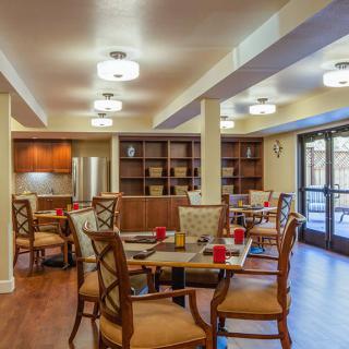 A cozy dining room with wooden furniture and soft lighting.