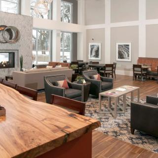 A modern lounge area with stylish furniture and wooden flooring.