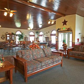 Cozy lobby area with wooden furniture and countryside decor.