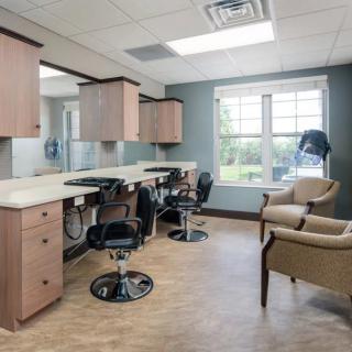 A well-lit hair salon interior with styling chairs and mirrors.