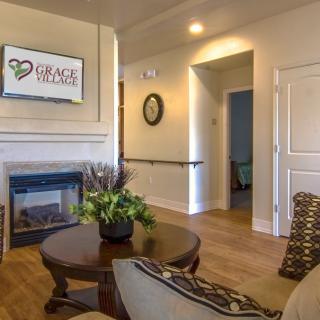 A cozy living room with a fireplace and comfortable seating area.