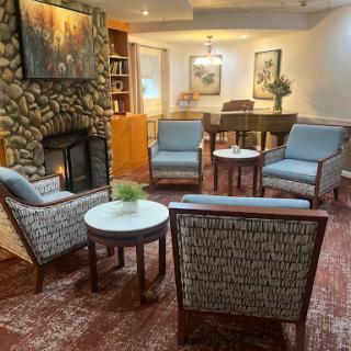 A cozy living room setting with comfortable chairs and a fireplace.