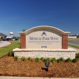 A sign for Medical Park West Rehabilitation and Skilled Care facility on a sunny day.
