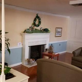 A cozy living room with a decorated fireplace and comfortable seating.