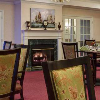 A cozy dining room with a fireplace and traditional decor.