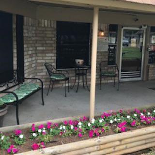 A cozy outdoor seating area adorned with vibrant flowers, perfect for relaxation.