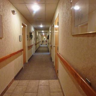 A well-lit hotel hallway showcasing the interior design and architecture.