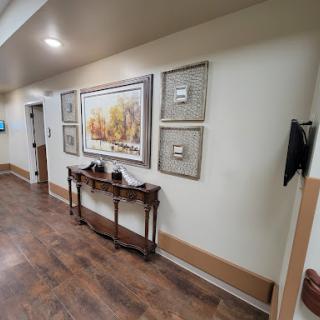 A well-decorated hallway featuring artwork and a wooden table.