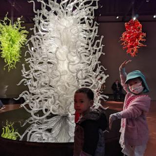 Children exploring a vibrant art installation in a museum.