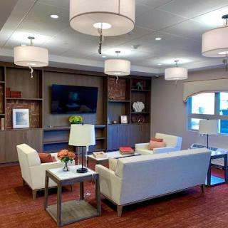 A cozy modern lounge area with stylish furniture and warm lighting.
