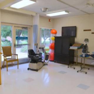 A rehabilitation room equipped with therapy tools and exercise equipment.