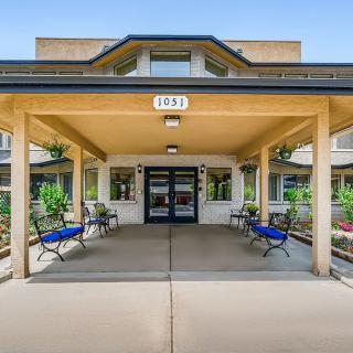 A covered entrance to a building with benches on either side.