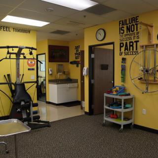 A fitness room with exercise equipment and motivational decor.