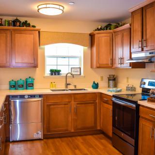 A cozy kitchen with wooden cabinets and stainless steel appliances.