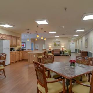 A spacious kitchen and dining area featuring modern lighting and wood flooring.