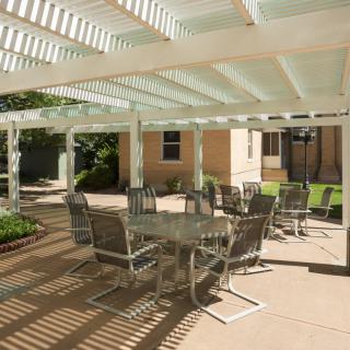 Outdoor patio area with a pergola and seating arrangements.