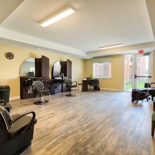 A bright and spacious salon interior with chairs, mirrors, and modern furniture.