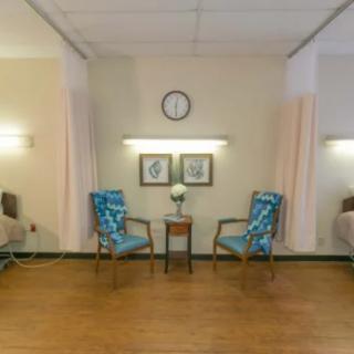 A calm and organized waiting area with chairs, a table, and wall decor.