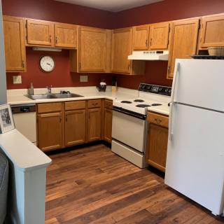 A cozy kitchen with wooden cabinets and modern appliances.