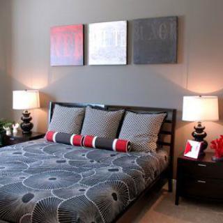 A modern bedroom with stylish bedding and contemporary decor.