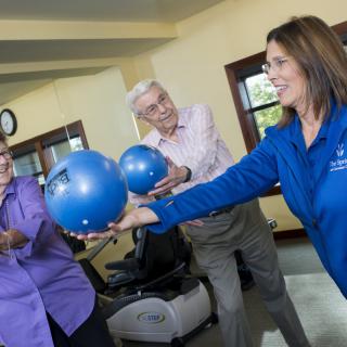Group of seniors participating in a fitness class with exercise balls.