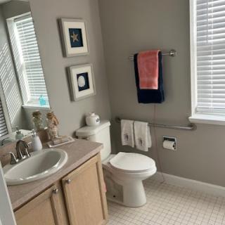 A well-lit, modern bathroom featuring neutral tones and contemporary fixtures.