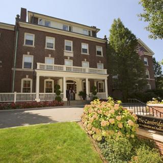 A brick building with a landscaped entrance and garden.