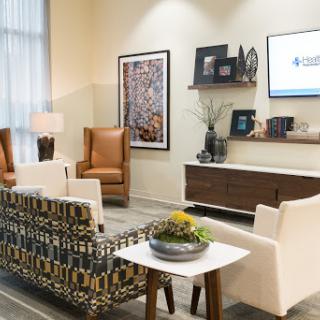 A modern waiting area featuring stylish furniture and decorative elements.
